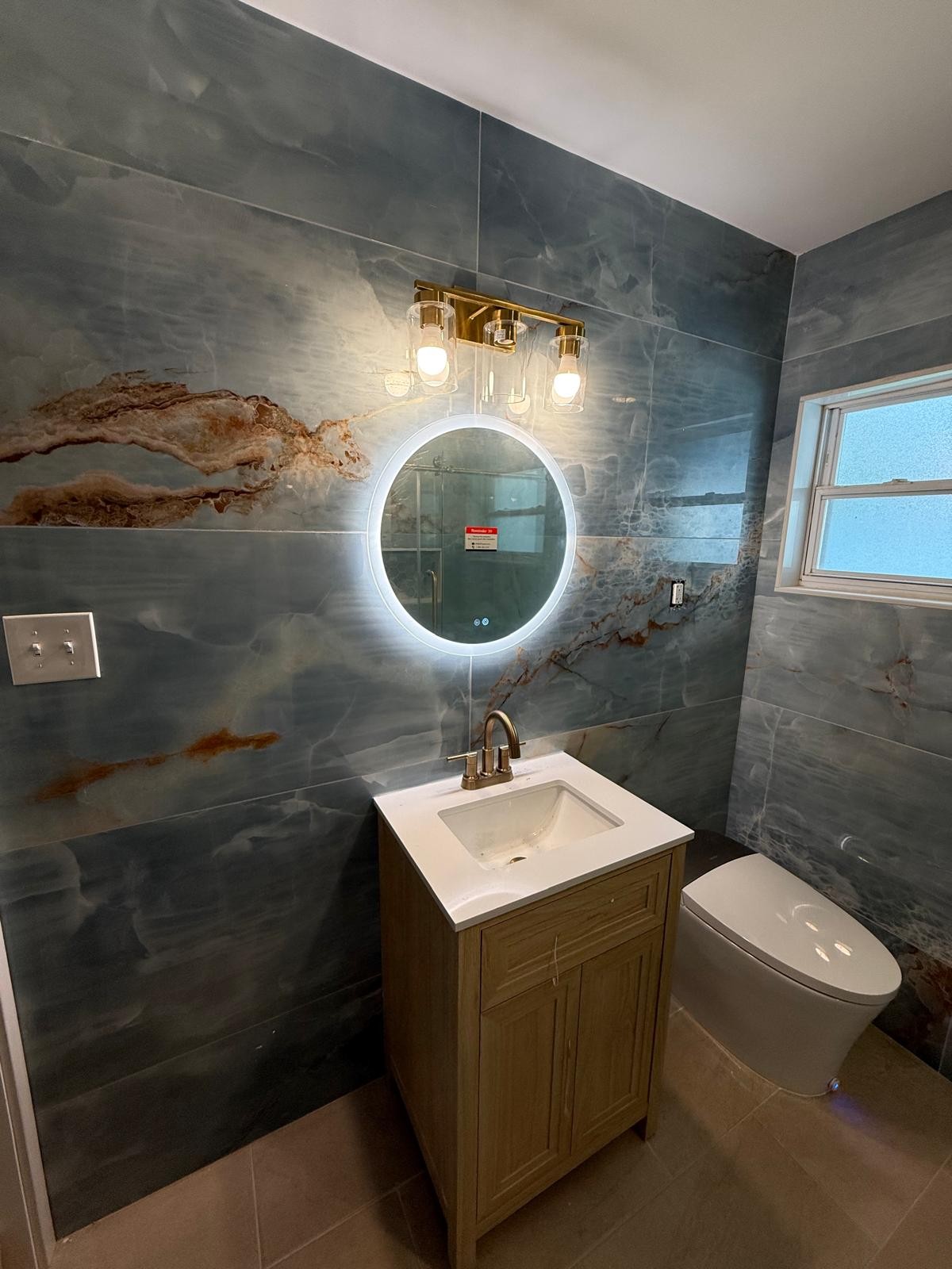 Floating timber vanity with dual illuminated LED mirrors and black faucets