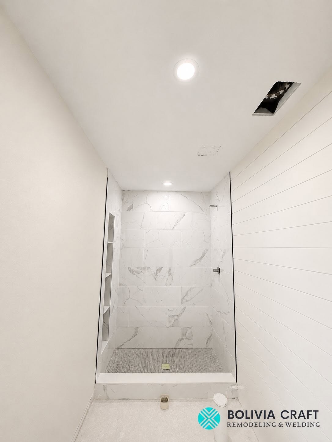 Calacatta marble recessed shower niche with brass schluter trim