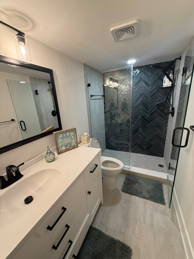 Navy subway herringbone shower accent wall
