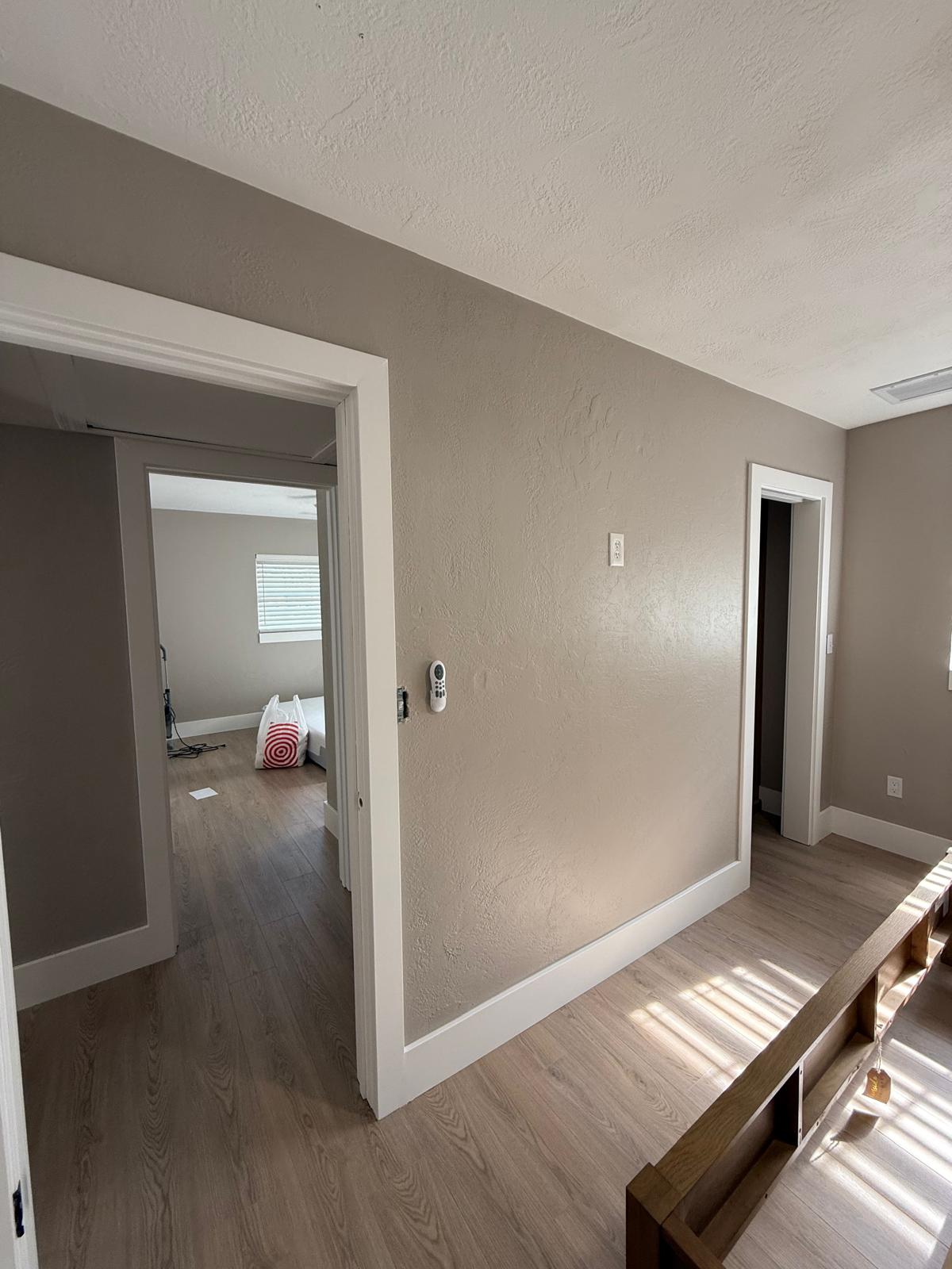 Rich deep navy accent bedroom wall with white craftsman trim